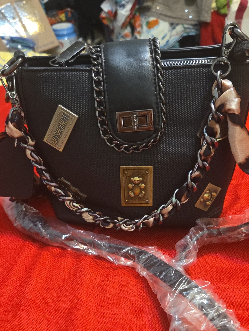 Black Chain-Accent Shoulder Bag with Decorative Plaques